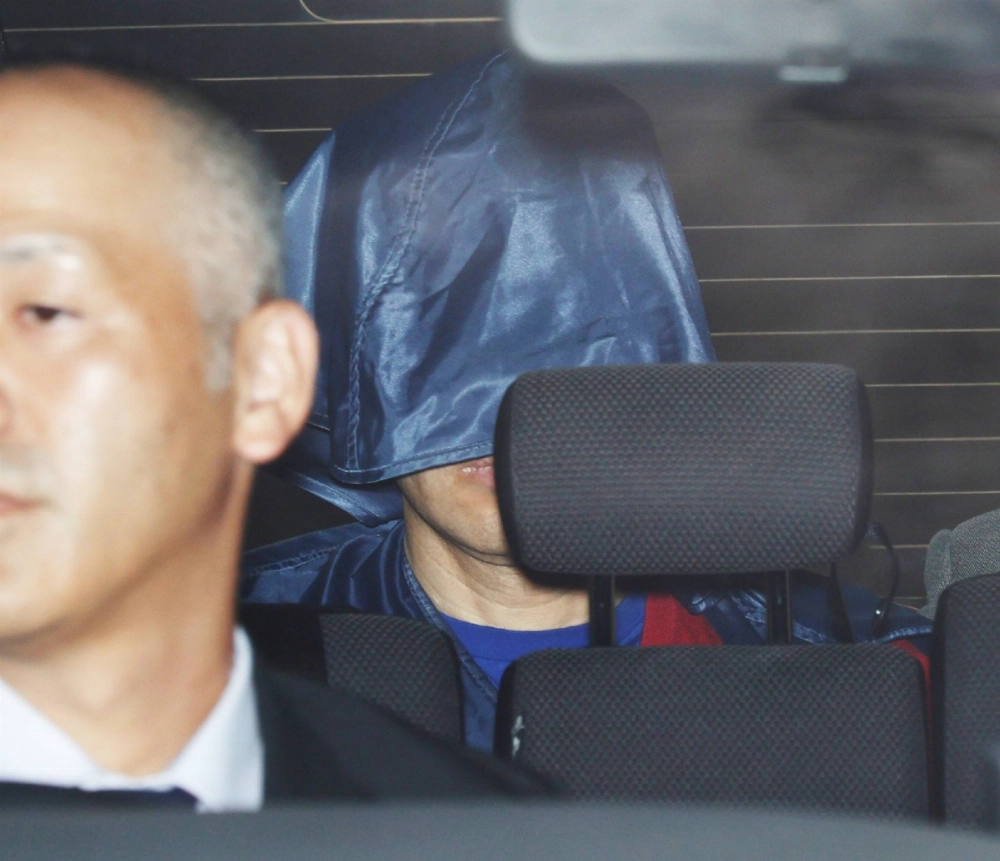 Kunihiko Katsuta is taken to Hyogo Prefectural Police's Tatsuno police station on Thursday after he was arrested for an attempted murder.  Kunihiko Katsuta is taken to Hyogo Prefectural Police's Tatsuno police station on Thursday after he was arrested for an attempted murder.