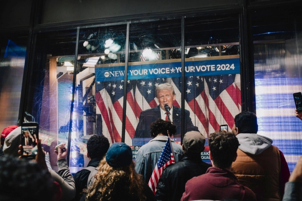 Onlookers watch a broadcast of Republican candidate Donald Trump addressing his election night watch party, in Times Square, New York, on Wednesday. Trump has been elected the 47th president of the United States, pulling off a stunning political comeback in one of the most polarized contests for the White House in U.S. history. Onlookers watch a broadcast of Republican candidate Donald Trump addressing his election night watch party, in Times Square, New York, on Wednesday. Trump has been elected the 47th president of the United States, pulling off a stunning political comeback in one of the most polarized contests for the White House in U.S. history.