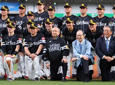 Masayoshi Son (front, center) poses with the members of the Fukuoka SoftBank Hawks after the team won the Pacific League championship at Kyocera Dome Osaka on Sept. 23. Masayoshi Son (front, center) poses with the members of the Fukuoka SoftBank Hawks after the team won the Pacific League championship at Kyocera Dome Osaka on Sept. 23.