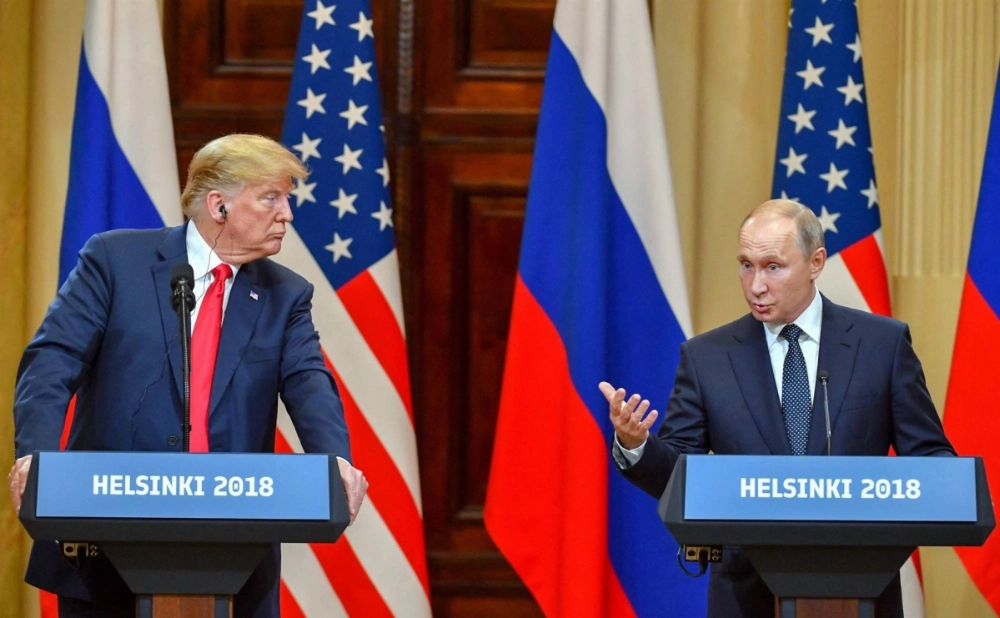 Then-U.S. President Donald Trump listens as Russian President Vladimir Putin speaks during a joint press conference at the Presidential Palace in Helsinki, in July 2018.  Then-U.S. President Donald Trump listens as Russian President Vladimir Putin speaks during a joint press conference at the Presidential Palace in Helsinki, in July 2018.