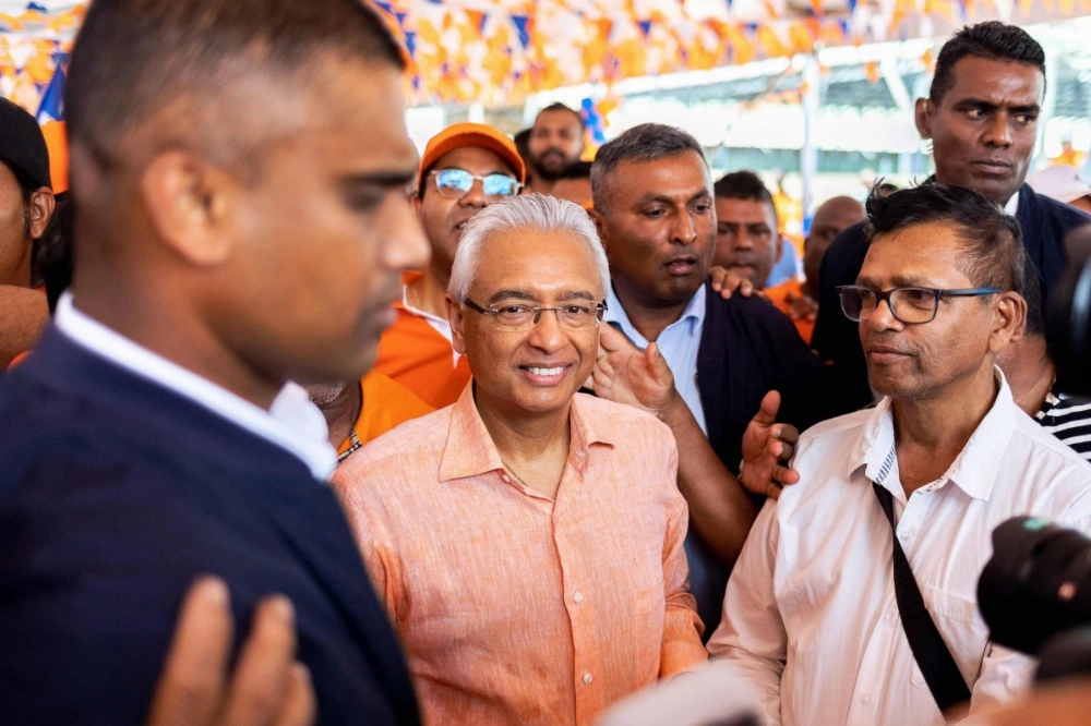 Prime Minister of Mauritius and candidate for the Militant Socialist Movement (MSM) Pravind Jugnauth (C) is surrounded by supporters during a campaign rally in Mahebourg on Oct. 20. Prime Minister of Mauritius and candidate for the Militant Socialist Movement (MSM) Pravind Jugnauth (C) is surrounded by supporters during a campaign rally in Mahebourg on Oct. 20.