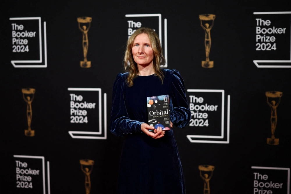British writer Samantha Harvey holds her book, "Orbital," while arriving for the Booker Prize Award announcement ceremony in London. British writer Samantha Harvey holds her book, "Orbital," while arriving for the Booker Prize Award announcement ceremony in London.