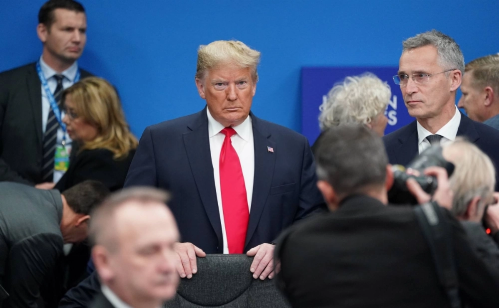 Then-U.S. President Donald Trump meets with NATO leaders at a plenary session of their summit in Watford, England, in December 2019.  Then-U.S. President Donald Trump meets with NATO leaders at a plenary session of their summit in Watford, England, in December 2019.