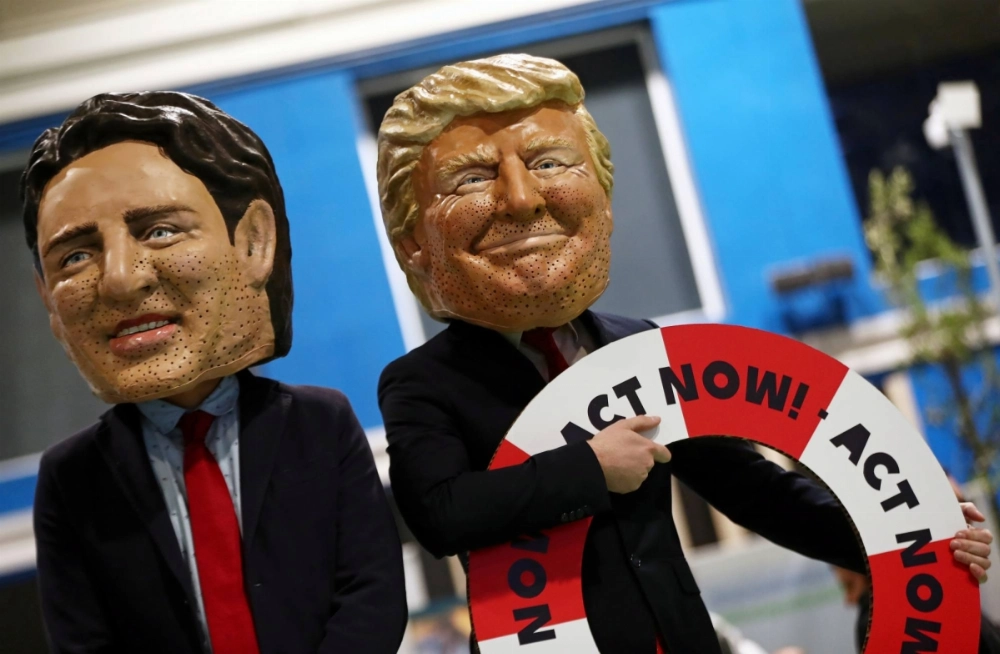 Activists wearing masks depicting then-U.S. President Donald Trump and Canadian Prime Minister Justin Trudeau take part in a protest outside the COP25 U.N. climate change conference in Madrid in December 2019.   Activists wearing masks depicting then-U.S. President Donald Trump and Canadian Prime Minister Justin Trudeau take part in a protest outside the COP25 U.N. climate change conference in Madrid in December 2019.