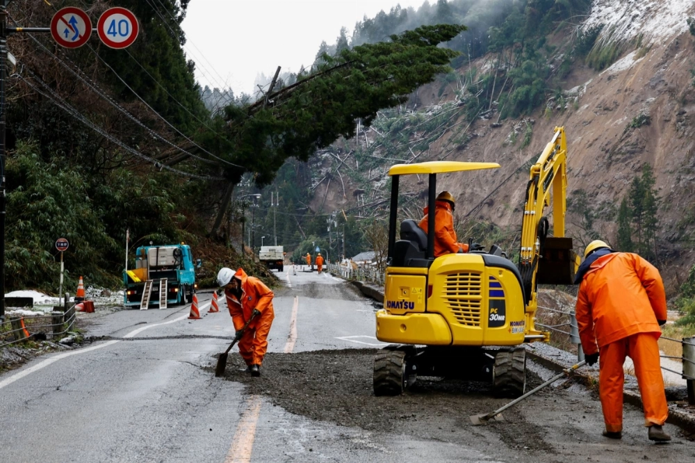 Workers repair a damaged road on Jan. 7 in the aftermath of an earthquake in Wajima, Ishikawa Prefecture. Workers repair a damaged road on Jan. 7 in the aftermath of an earthquake in Wajima, Ishikawa Prefecture.