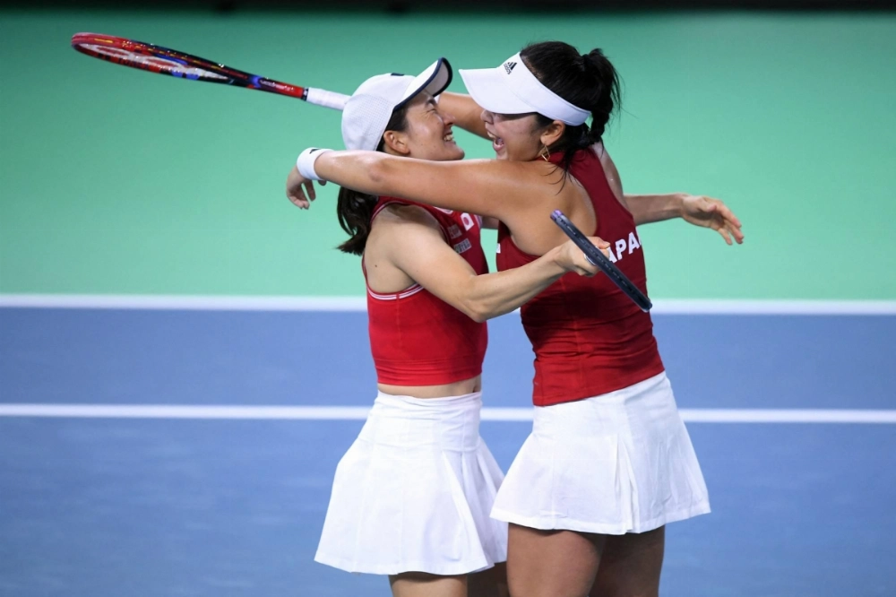 Japan's Shuko Aoyama (left) and Eri Hozumi celebrate after defeating the Romanian pair of Monica Niculescu and Elena Ruse during the Billie Jean Cup in Malaga, Spain, on Thursday. Japan's Shuko Aoyama (left) and Eri Hozumi celebrate after defeating the Romanian pair of Monica Niculescu and Elena Ruse during the Billie Jean Cup in Malaga, Spain, on Thursday.