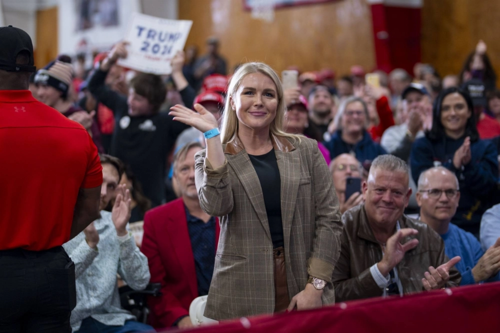 Karoline Leavitt waves during a campaign event at the New England Sports Center in Derry, New Hampshire, in October 2023.  Karoline Leavitt waves during a campaign event at the New England Sports Center in Derry, New Hampshire, in October 2023.