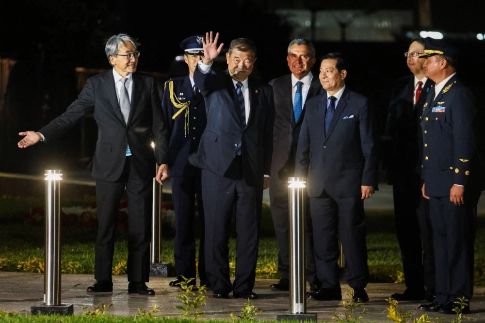 Prime Minister Shigeru Ishiba waves upon arrival for the Asia-Pacific Economic Cooperation forum, in Callao, Peru, on Friday. Prime Minister Shigeru Ishiba waves upon arrival for the Asia-Pacific Economic Cooperation forum, in Callao, Peru, on Friday.