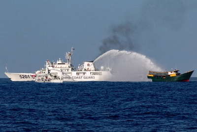 A China Coast Guard vessel fires a water cannon at a Philippine boat on a resupply mission to the Second Thomas Shoal in the South China Sea on March 5. A China Coast Guard vessel fires a water cannon at a Philippine boat on a resupply mission to the Second Thomas Shoal in the South China Sea on March 5.