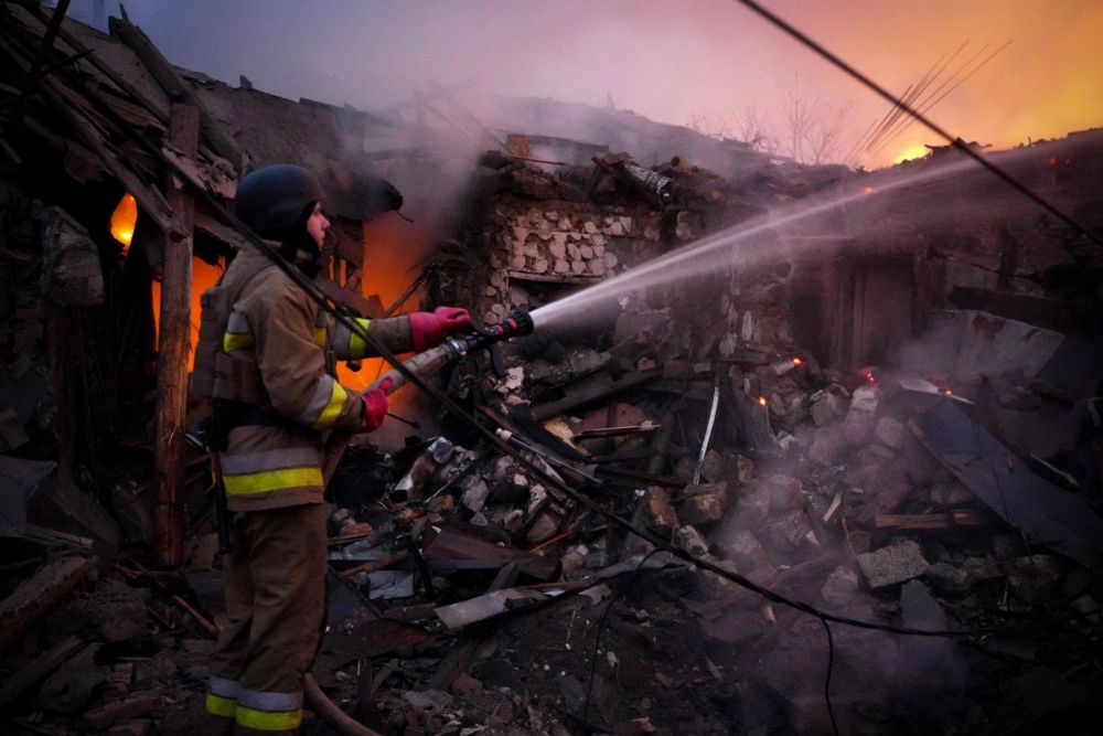 A Ukrainian rescuer works to extinguish a fire in a building following a drone attack in Mykolaiv, Ukraine, on Sunday.  A Ukrainian rescuer works to extinguish a fire in a building following a drone attack in Mykolaiv, Ukraine, on Sunday.