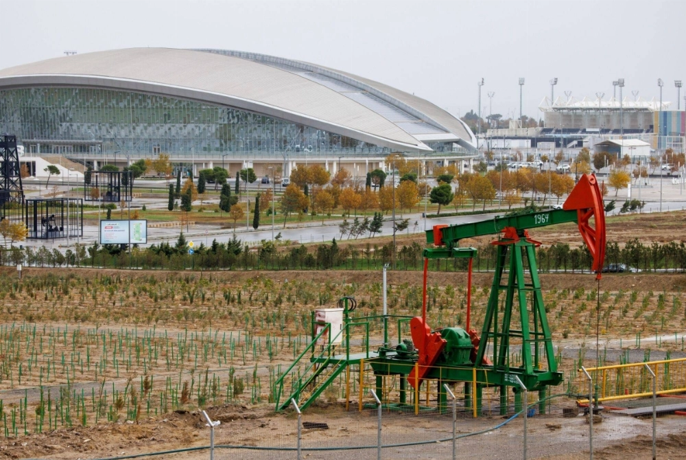 An oil pump jack and drilling rigs in an oilfield on the shore of the Caspian Sea, near the Aquatic Palace stadium in Baku, Azerbaijan, on Thursday. An oil pump jack and drilling rigs in an oilfield on the shore of the Caspian Sea, near the Aquatic Palace stadium in Baku, Azerbaijan, on Thursday.