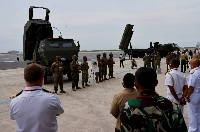 A U.S. Marine Corps M142 High Mobility Artillery Rocket System (HIMARS) and a Japanese Ground Self-Defense Force Type 12 Surface-to-Ship Missile (12SSM) system are put on display at a symposium at a base in Kisarazu, Japan, in June 2022.  | REUTERS