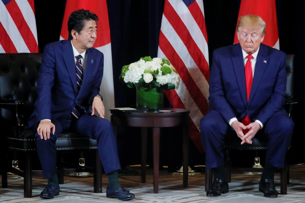 U.S. President Donald Trump holds a bilateral meeting with then-Prime Minister Shinzo Abe on the sidelines of the United Nations General Assembly in New York in September 2019. Tokyo may be forced to balance its priorities in the U.S. alliance with its economic reliance on China. U.S. President Donald Trump holds a bilateral meeting with then-Prime Minister Shinzo Abe on the sidelines of the United Nations General Assembly in New York in September 2019. Tokyo may be forced to balance its priorities in the U.S. alliance with its economic reliance on China.