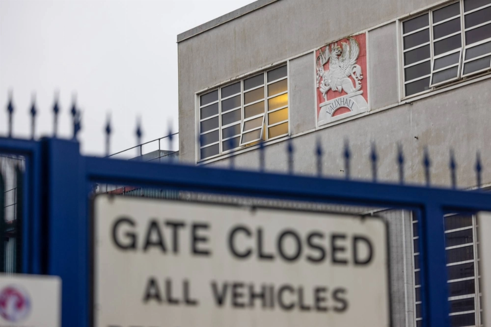 A sign at the entrance to the Vauxhall van factory in Luton, England, on Nov. 27. Stellantis plans to close the factory, and has made efforts to pin the blame on the government's mandate for more electric vehicle sales. A sign at the entrance to the Vauxhall van factory in Luton, England, on Nov. 27. Stellantis plans to close the factory, and has made efforts to pin the blame on the government's mandate for more electric vehicle sales.