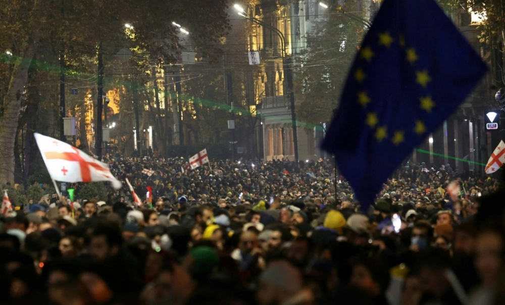 Thousands of people gather for a third night of protests against the government's decision to shelve European Union membership talks until 2028, near the parliament building in Tbilisi on Saturday. Thousands of people gather for a third night of protests against the government's decision to shelve European Union membership talks until 2028, near the parliament building in Tbilisi on Saturday.