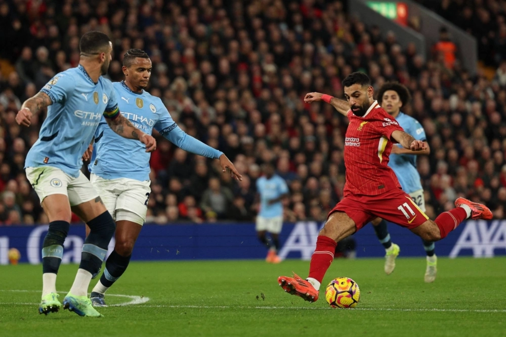 Liverpool's Mohamed Salah takes a shot against Manchester City during their Premier League match in Liverpool, England, on Sunday.  Liverpool's Mohamed Salah takes a shot against Manchester City during their Premier League match in Liverpool, England, on Sunday.