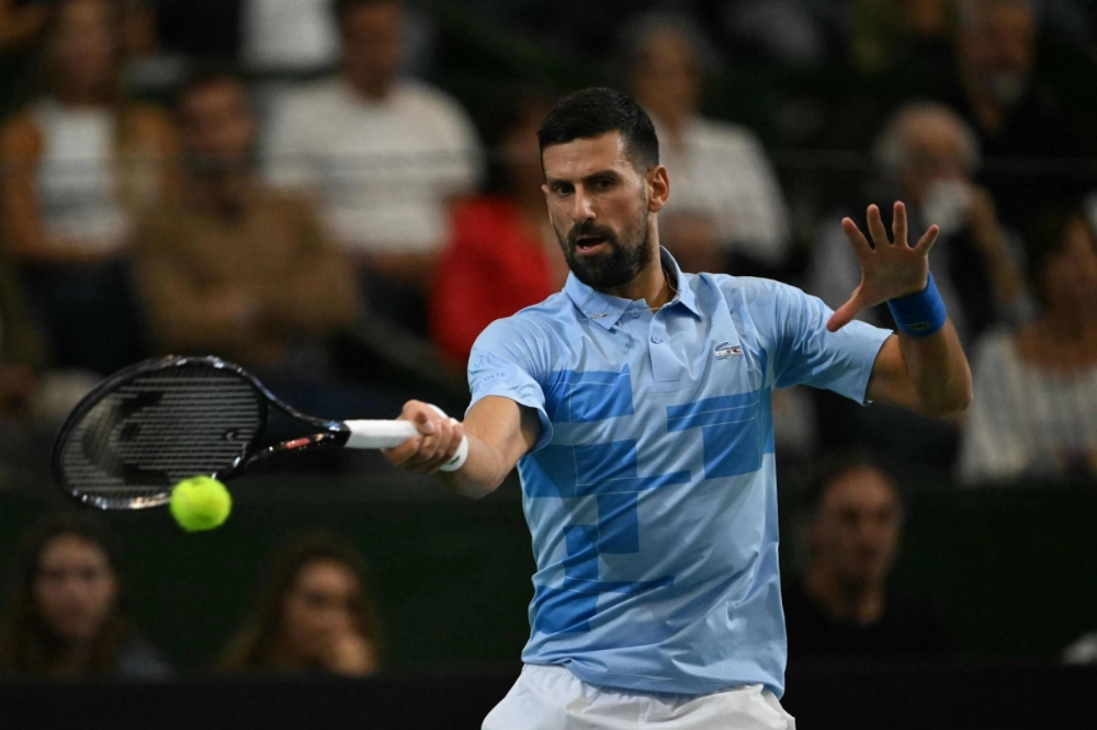 Novak Djokovic hits a return against Juan Martin del Potro during an exhibition in Buenos Aires on Sunday. Novak Djokovic hits a return against Juan Martin del Potro during an exhibition in Buenos Aires on Sunday.