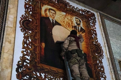 An anti-regime fighter tears off a poster depicting Syrian President Bashar Assad (left) and his brother Maher at the airport in the northern Syrian city of Aleppo on Monday. An anti-regime fighter tears off a poster depicting Syrian President Bashar Assad (left) and his brother Maher at the airport in the northern Syrian city of Aleppo on Monday.