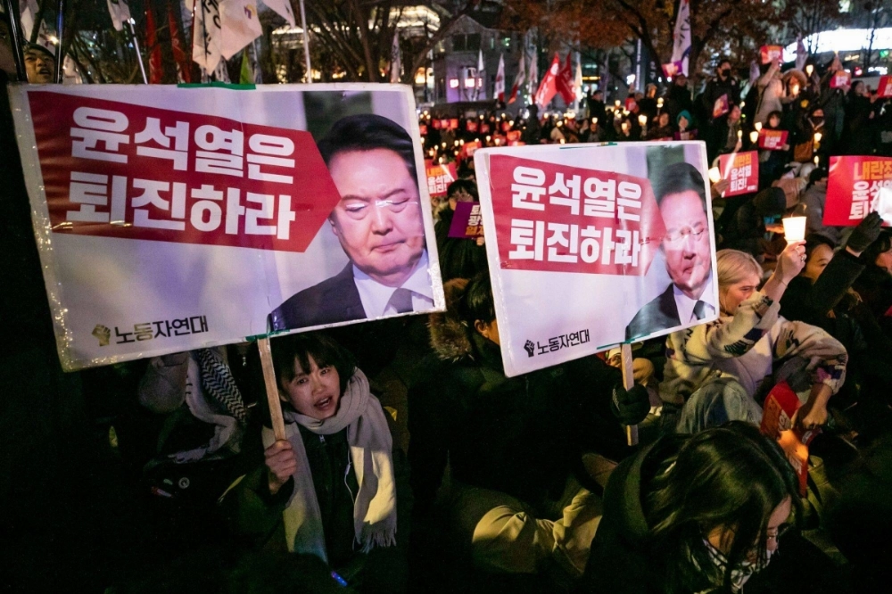 Protesters call for the resignation of South Korean President Yoon Suk Yeol during a demonstration in Seoul on Wednesday. Protesters call for the resignation of South Korean President Yoon Suk Yeol during a demonstration in Seoul on Wednesday.