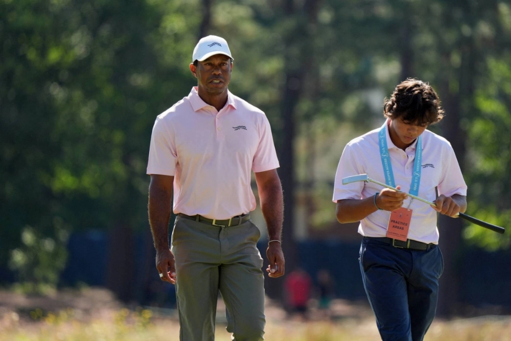 Tiger Woods and his son Charlie Woods walk off the seventh green during a practice round for the U.S. Open golf tournament in Pinehurst, North Carolina, on June 11. Tiger Woods and his son Charlie Woods walk off the seventh green during a practice round for the U.S. Open golf tournament in Pinehurst, North Carolina, on June 11.