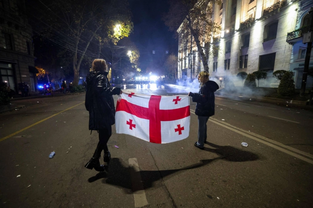 Georgian anti-government protesters face off against police during consecutive days of mass demonstrations against the government's postponement of European Union accession talks in central Tbilisi on Dec. 3. Georgian anti-government protesters face off against police during consecutive days of mass demonstrations against the government's postponement of European Union accession talks in central Tbilisi on Dec. 3.