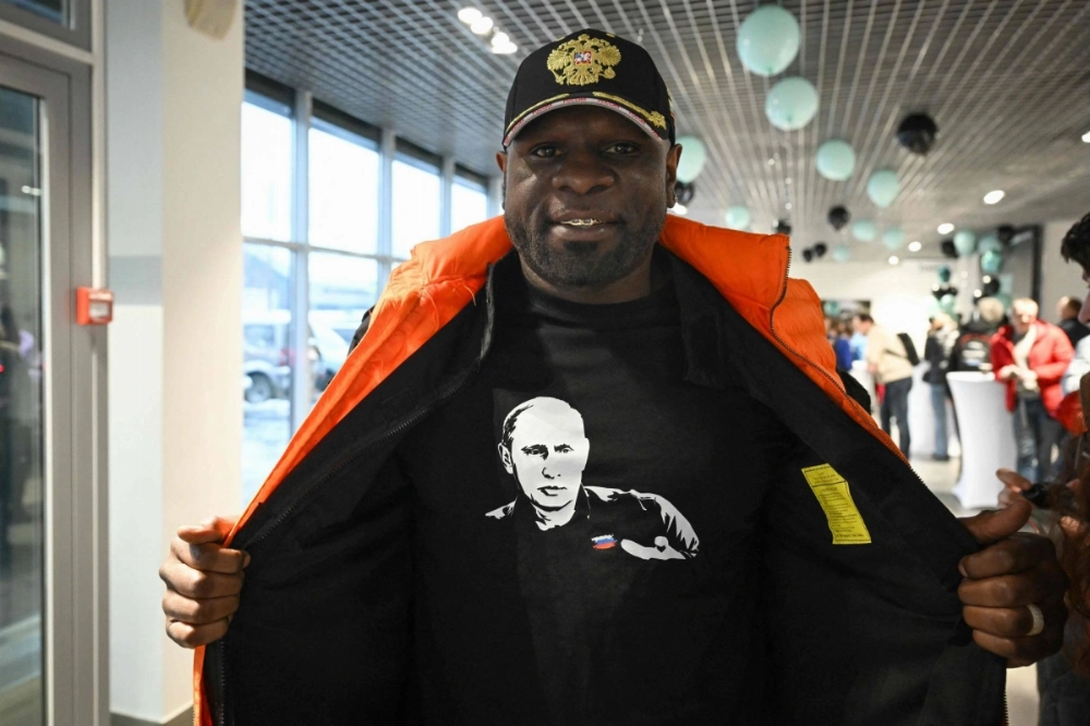 Boxer Kevin Johnson displays a shirt with an image of Vladimir Putin in Moscow on Nov. 24. Boxer Kevin Johnson displays a shirt with an image of Vladimir Putin in Moscow on Nov. 24.