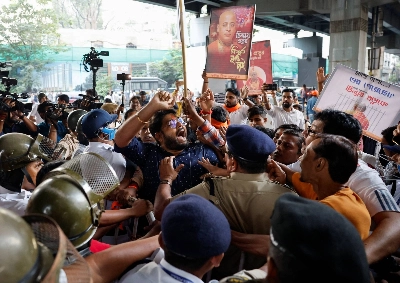 Indian activists angered over the jailing of a leading Hindu monk in Bangladesh try to break a police barricade during a protest in Kolkata on Nov. 28 demanding his release. Indian activists angered over the jailing of a leading Hindu monk in Bangladesh try to break a police barricade during a protest in Kolkata on Nov. 28 demanding his release.