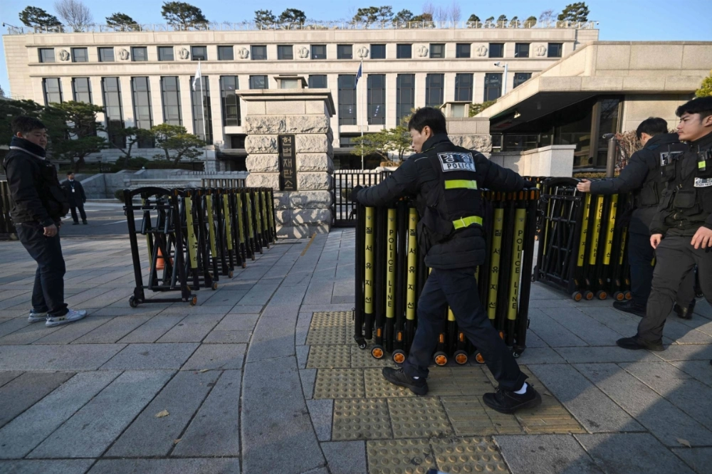 Policemen set up barricades in front of the South Korean Constitutional Court in Seoul on Monday as the court kicked off its first meeting of its justices to review the parliamentary impeachment of President Yoon Suk Yeol. Policemen set up barricades in front of the South Korean Constitutional Court in Seoul on Monday as the court kicked off its first meeting of its justices to review the parliamentary impeachment of President Yoon Suk Yeol.
