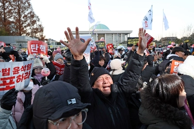 A demonstrator reacts after lawmakers passed a motion to impeach South Korean President Yoon Suk Yeol on Saturday. A demonstrator reacts after lawmakers passed a motion to impeach South Korean President Yoon Suk Yeol on Saturday.