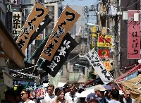 Foreign tourists visit Tsukiji Outer Market in Tokyo in June. | Reuters