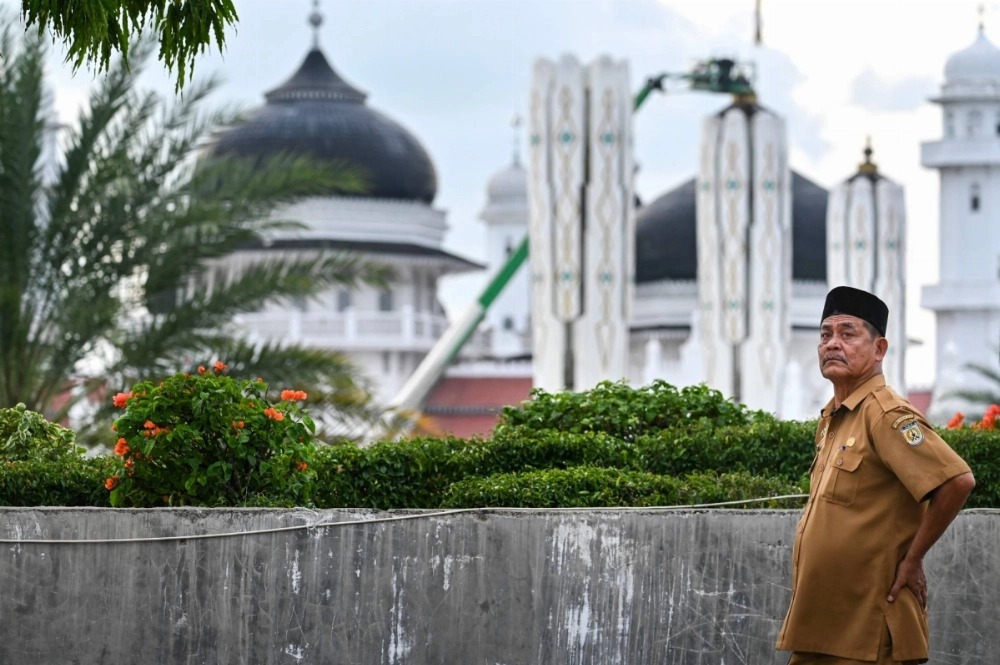Djafaruddin poses for a photograph near the Baiturrahman Grand Mosque in Banda Aceh, Indonesia. Djafaruddin poses for a photograph near the Baiturrahman Grand Mosque in Banda Aceh, Indonesia.