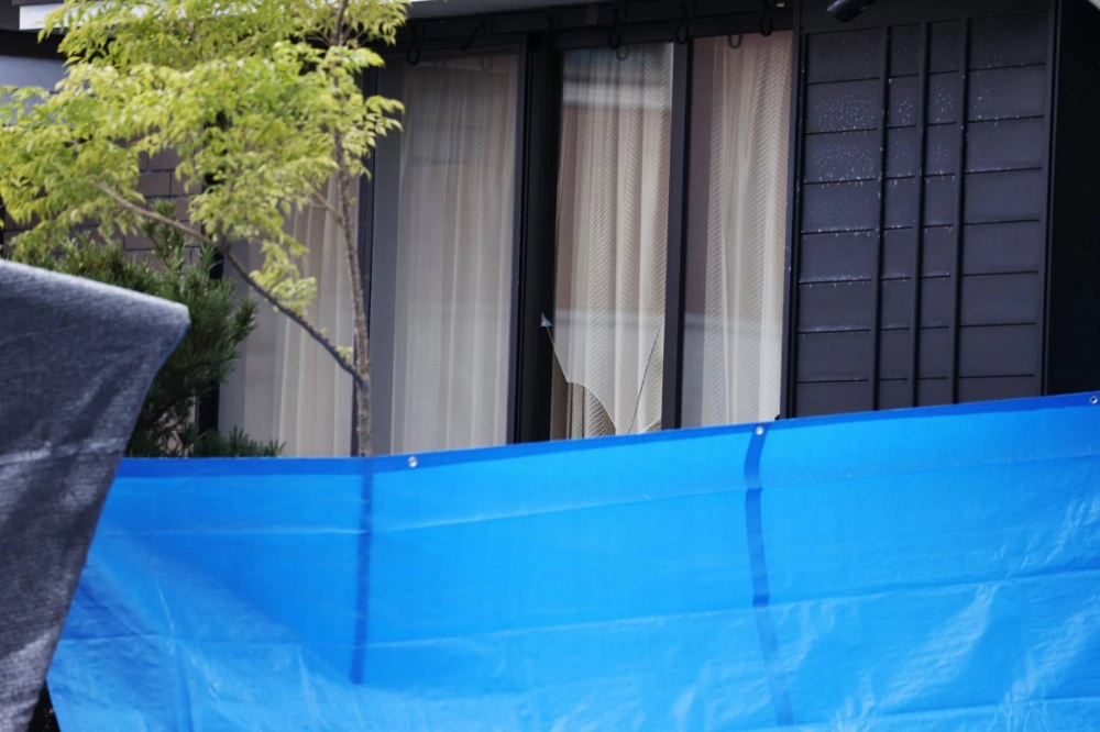 Broken window glass is seen at Masanori Hirabaru's house in Kitakyushu's Kokuraminami Ward. Broken window glass is seen at Masanori Hirabaru's house in Kitakyushu's Kokuraminami Ward.