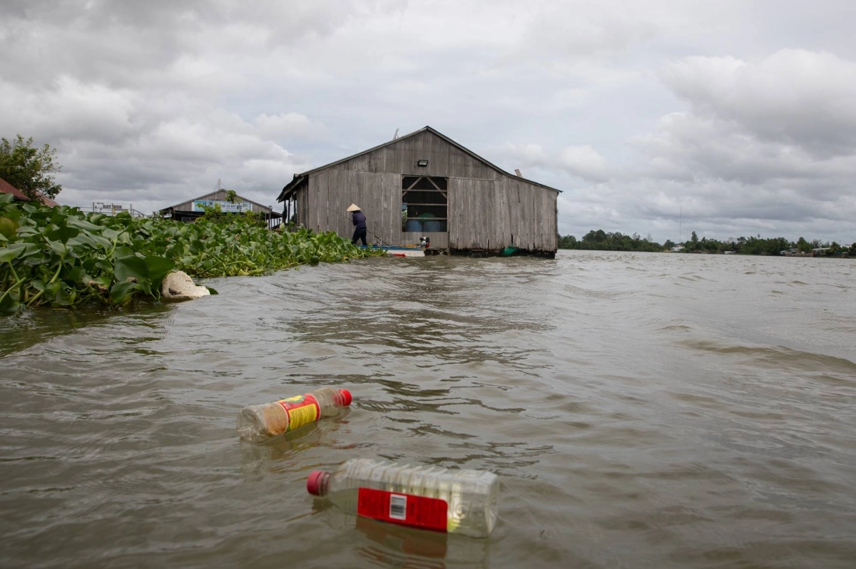 Plastic bottles float in Vietnam's Mekong Delta as a fisherman returns to a dock by Can Tho City, the largest city in Vietnam's Mekong Delta. Plastic bottles float in Vietnam's Mekong Delta as a fisherman returns to a dock by Can Tho City, the largest city in Vietnam's Mekong Delta.