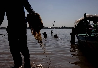 Children swim at the confluence of the Mekong and Tonle Sap rivers in Phnom Penh as workers clear the banks of plastic waste. | Anton L. Delgado
