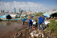 A group of workers from River Ocean CleanUp pick up trash at the confluence of the Mekong and Tonle Sap rivers in Phnom Penh. | Anton L. Delgado