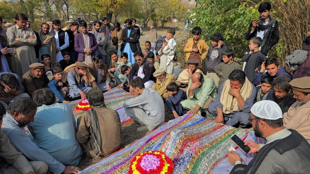 People mourn over the graves of relatives who were killed after gunmen opened fire on passenger vehicles in the Kurram tribal district of Khyber Pakhtunkhwa province, in Shalozan, Pakistan, on Nov. 22. People mourn over the graves of relatives who were killed after gunmen opened fire on passenger vehicles in the Kurram tribal district of Khyber Pakhtunkhwa province, in Shalozan, Pakistan, on Nov. 22.