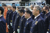 Japan Coast Guard officers and others observed a moment of silence at a memorial ceremony on Monday in Tokyo's Ota Ward. | Jiji