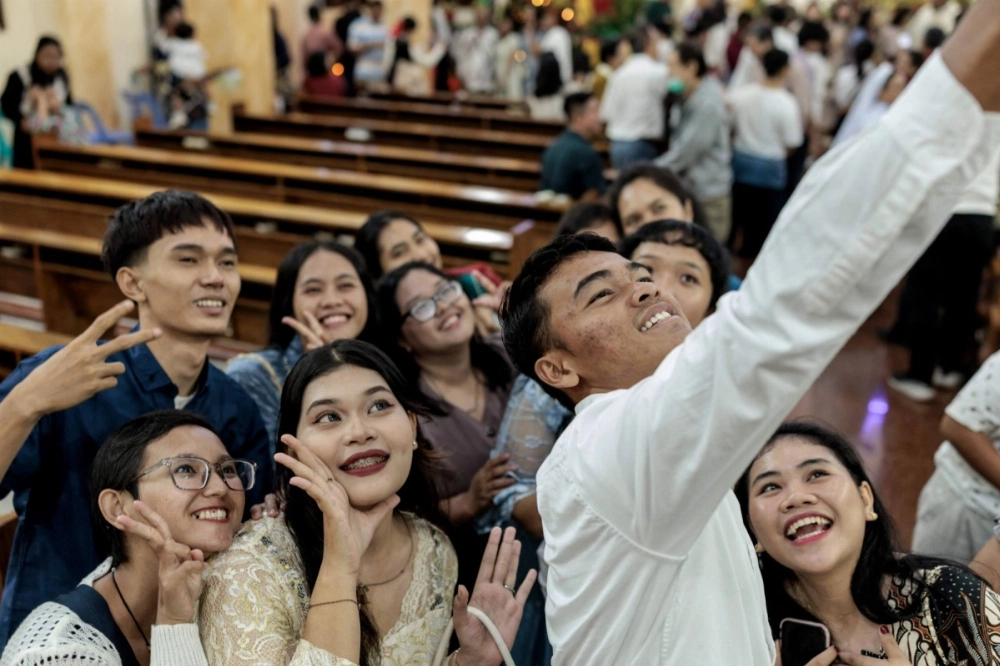 Christians take selfies after a Christmas Eve Mass at the Sacred Heart Catholic Church in Banda Aceh, Sumatra, Indonesia, on Tuesday, ahead of the 20th anniversary of a magnitude 9.1 earthquake that struck the coast of Sumatra on Dec. 26, 2004, triggering a huge tsunami across the Indian Ocean. Christians take selfies after a Christmas Eve Mass at the Sacred Heart Catholic Church in Banda Aceh, Sumatra, Indonesia, on Tuesday, ahead of the 20th anniversary of a magnitude 9.1 earthquake that struck the coast of Sumatra on Dec. 26, 2004, triggering a huge tsunami across the Indian Ocean.