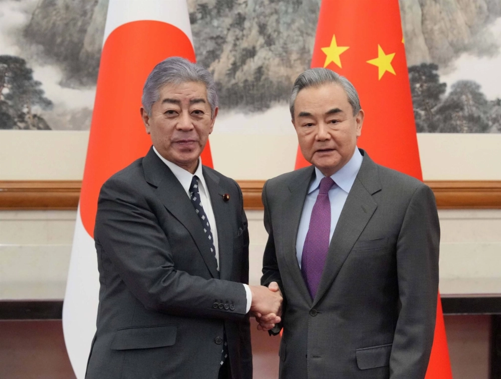 Foreign Minister Takeshi Iwaya (left) and his Chinese counterpart, Wang Yi, in Beijing on Wednesday Foreign Minister Takeshi Iwaya (left) and his Chinese counterpart, Wang Yi, in Beijing on Wednesday