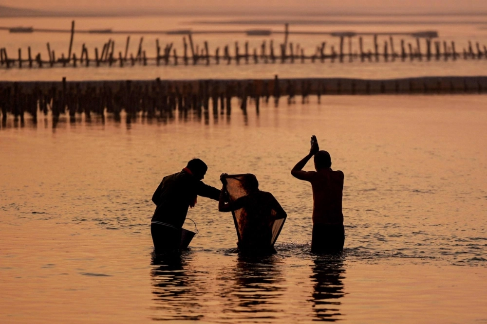 Hindu pilgrims take a dip along the banks of Sangam, ahead of the <i>maha</i> Kumbh Mela festival in the city of Prayagraj on Sunday. Beside India's holy rivers, a makeshift city is being built for a Hindu religious festival expected to be so vast it will be seen from space. Hindu pilgrims take a dip along the banks of Sangam, ahead of the <i>maha</i> Kumbh Mela festival in the city of Prayagraj on Sunday. Beside India's holy rivers, a makeshift city is being built for a Hindu religious festival expected to be so vast it will be seen from space.