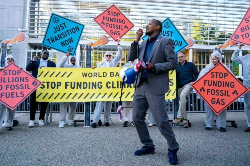 Climate demonstrators protest against investments in fossil fuels during the annual meetings of the International Monetary Fund and World Bank in Washington on Oct. 21. Climate demonstrators protest against investments in fossil fuels during the annual meetings of the International Monetary Fund and World Bank in Washington on Oct. 21.