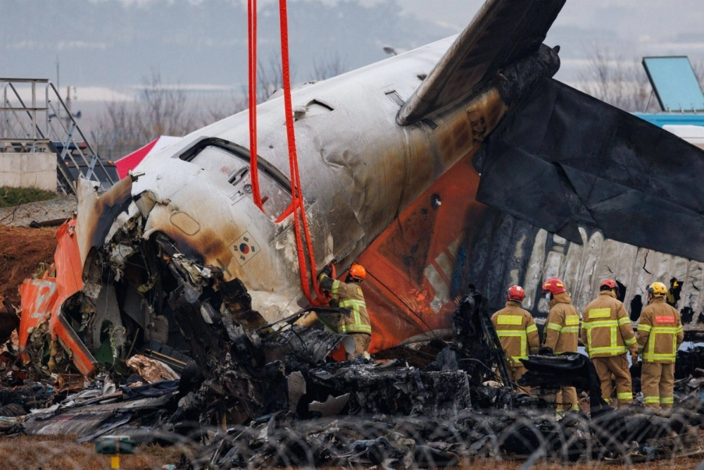 Firefighters on Monday inspect the wreckage of a Jeju Air plane that crashed at Muan International Airport in Muan, South Korea, a day earlier. Firefighters on Monday inspect the wreckage of a Jeju Air plane that crashed at Muan International Airport in Muan, South Korea, a day earlier.