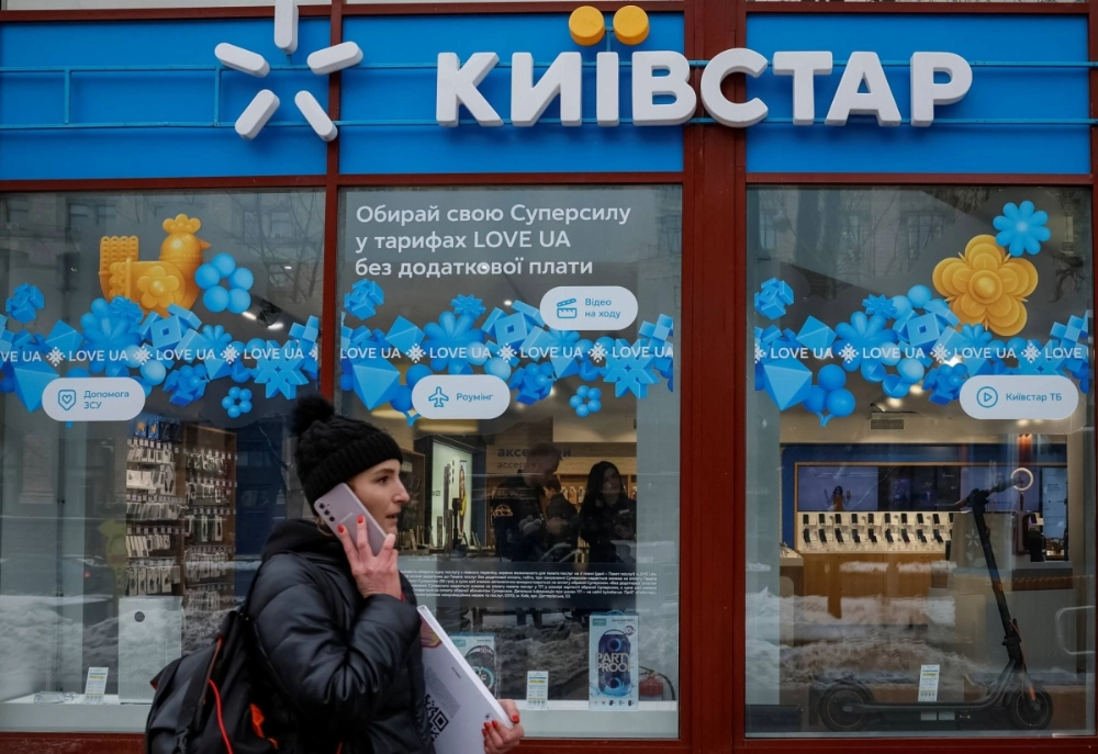 A woman walks past a store of Ukraine's telecommunications company Kyivstar in Kyiv on Dec.12, 2023.  A woman walks past a store of Ukraine's telecommunications company Kyivstar in Kyiv on Dec.12, 2023.