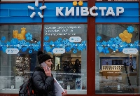 A woman walks past a store of Ukraine's telecommunications company Kyivstar in Kyiv on Dec.12, 2023.  | REUTERS