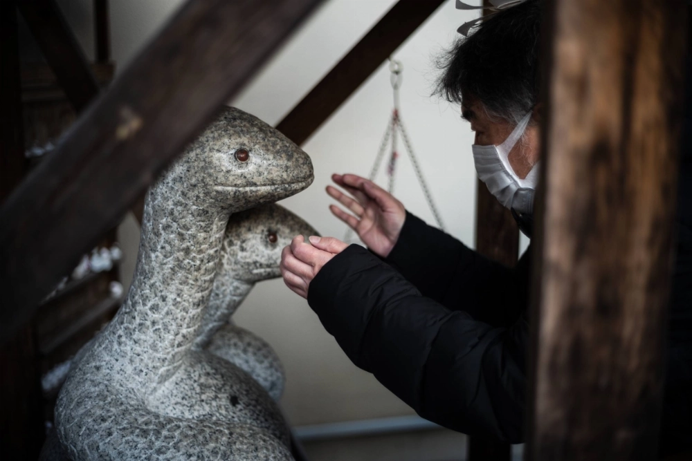 A man offers prayers at Hebikubo Shrine in Tokyo's Shinagawa Ward. The shrine is one of several across the country dedicated to the snake.  A man offers prayers at Hebikubo Shrine in Tokyo's Shinagawa Ward. The shrine is one of several across the country dedicated to the snake.
