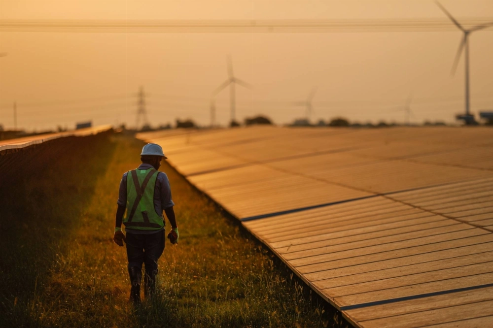 A maintenance worker inspects solar panels at a power plant in southern India.  A maintenance worker inspects solar panels at a power plant in southern India.