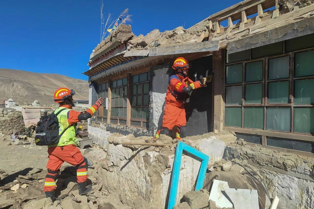 Rescuers inspect a damaged house following a powerful earthquake that struck Shigatse in southwestern China's Tibet region on Wednesday. Rescuers inspect a damaged house following a powerful earthquake that struck Shigatse in southwestern China's Tibet region on Wednesday.