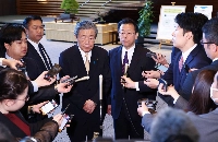 After meeting with Prime Minister Shigeru Ishiba, LDP Secretary-General Hiroshi Moriyama (center left) and his Komeito counterpart, Makoto Nishida (center right) answer questions from the media on Thursday at the Prime Minister's Office.  | Jiji