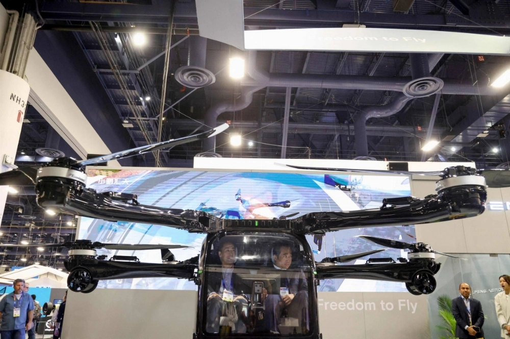 Attendees sit in Xpeng's modular "flying car" during the Consumer Electronics Show in Las Vegas on Tuesday.  Attendees sit in Xpeng's modular "flying car" during the Consumer Electronics Show in Las Vegas on Tuesday.
