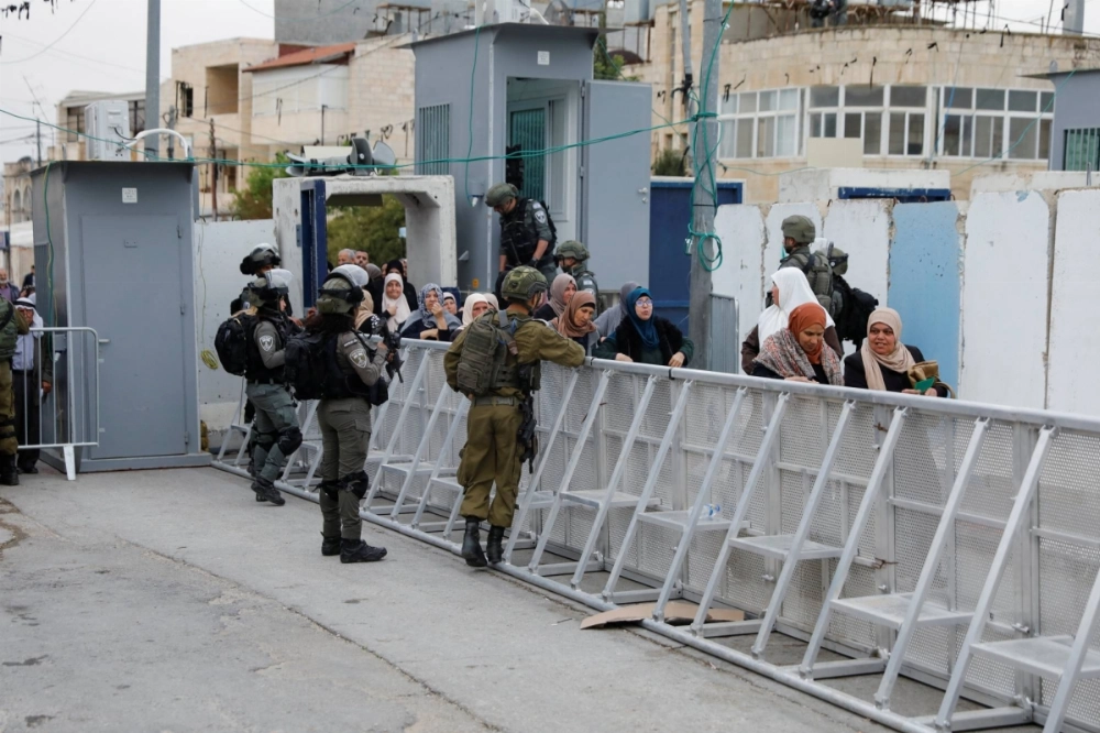 Palestinians pass through an Israeli checkpoint as they make their way to Jerusalem's al-Aqsa compound, known to Jews as the Temple Mount, in the West Bank, in March 2024. Israeli forces have frequently used disguises to infiltrate Gaza and target Hamas operatives. 
 Palestinians pass through an Israeli checkpoint as they make their way to Jerusalem's al-Aqsa compound, known to Jews as the Temple Mount, in the West Bank, in March 2024. Israeli forces have frequently used disguises to infiltrate Gaza and target Hamas operatives.